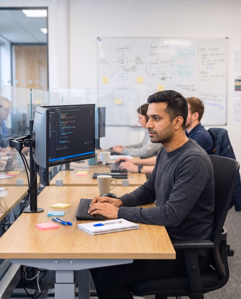 A data and AI engineer working at a two-screen workstation